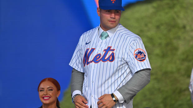 Jul 17, 2022; Los Angeles, CA, USA; Kevin Parada puts on a jersey after he was selected by the New York Mets as the 11th player in the MLB draft at XBox Plaza at LA Live.