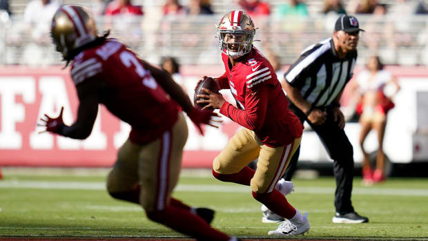 San Francisco 49ers quarterback Trey Lance (5) rolls out against the Green Bay Packers during the first half of an NFL preseason football game in Santa Clara, Calif., Friday, Aug. 12, 2022.
