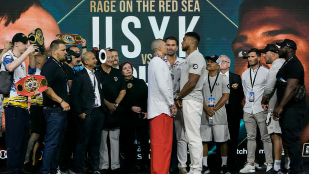 Heavyweight boxers Britain’s Anthony Joshua, center right, and Ukraine’s Oleksandr Usyk, center left, face off during a weigh-in at King Abdullah Sports City in Jeddah, Saudi Arabia, Friday, Aug. 19, 2022. Joshua is due to fight defending champion Usyk in a heavyweight boxing rematch in Jeddah on Aug. 20.