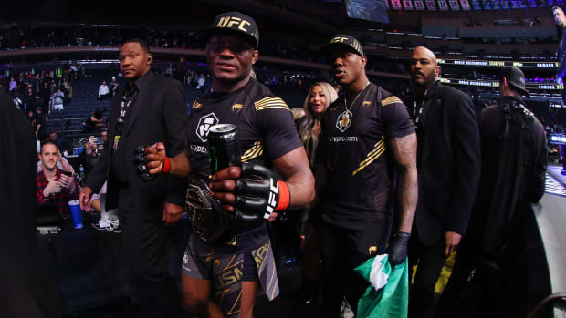 Nov 6, 2021; New York, NY, USA; Kamaru Usman (red gloves) leaves the octagon with his championship belt after defeating Colby Covington (blue gloves) during UFC 268 at Madison Square Garden.