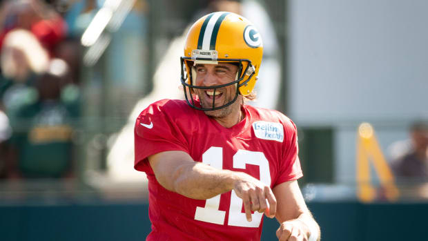 Green Bay Packers quarterback Aaron Rodgers (12) smiles at training camp on Tuesday, Aug. 16, 2022, at Ray Nitschke Field in Ashwaubenon, Wis.