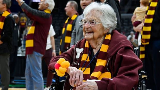 Loyola Ramblers fan Sister Jean smiles and looks on as the Ramblers men’s basketball team receives the Missouri Valley Trophy.