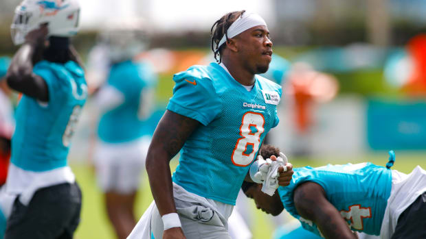Dolphins safety Jevon Holland runs on the field during training camp.
