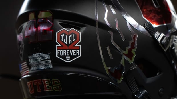 Utah Utes players commemorate fallen teammates running back Ty Jordan (22) and cornerback Aaron Lowe (22) with decals on their helmets before the game against the Stanford Cardinal at Stanford Stadium.