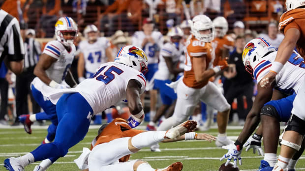 Nov 13, 2021; Austin, Texas, USA; Kansas Jayhawks defensive end Kyron Johnson (15) forces and recovers a fumble during the first half against the Texas Longhorns at Darrell K Royal-Texas Memorial Stadium. Mandatory Credit: Scott Wachter-USA TODAY Sports