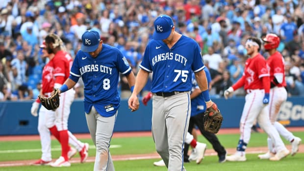 Jul 16, 2022; Toronto, Ontario, CAN; Kansas City Royals third baseman Nicky Lopez (8) and left fielder Brewer Hicklen (75) walk off the field as the Toronto Blue Jays celebrate a victory in the 10th inning at Rogers Centre. Mandatory Credit: Dan Hamilton-USA TODAY Sports