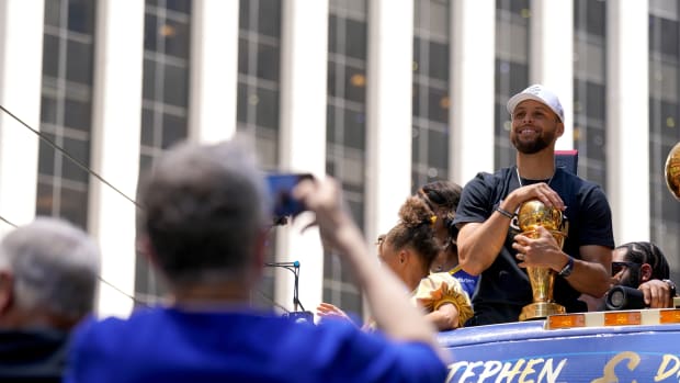 Jun 20, 2022; San Francisco, CA, USA; Golden State Warriors guard Stephen Curry smiles with the NBA Finals Most Valuable Player Award trophy during the Warriors championship parade in downtown San Francisco. Mandatory Credit: Cary Edmondson-USA TODAY Sports