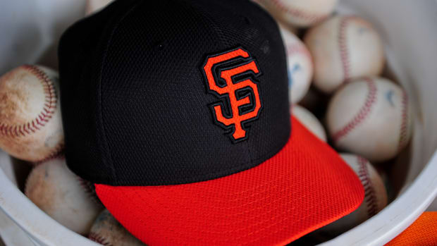 A SF Giants giants hat sits in a bucket of baseballs during spring training (2015).