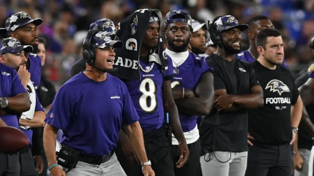 Aug 11, 2022; Baltimore, Maryland, USA; Baltimore Ravens head coach John Harbaugh reacts while standing with quarterback Lamar Jackson (8) during the game against the Tennessee Titans at M&T Bank Stadium.