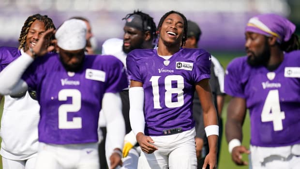 Minnesota Vikings wide receiver Justin Jefferson, center, smiles while taking part in a joint practice with the San Francisco 49ers during NFL football training camp in Eagan, Minn., Thursday, Aug. 18, 2022.