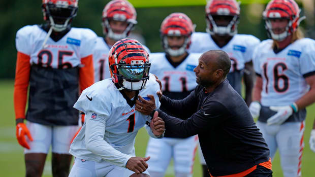 Cincinnati Bengals wide receiver Ja'Marr Chase (1) runs through a drill with wide receivers coach Troy Walters during a training camp practice at the Paycor Stadium practice fields in downtown Cincinnati on Wednesday, Aug. 17, 2022. Cincinnati Bengals Training Camp