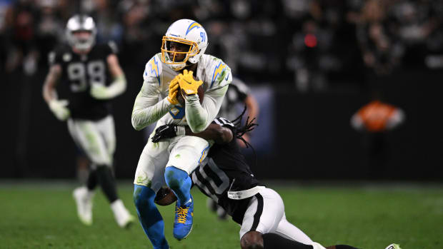 Jan 9, 2022; Paradise, Nevada, USA; Los Angeles Chargers wide receiver Mike Williams (81) runs with the ball after a catch while tackled by Las Vegas Raiders cornerback Desmond Trufant (10) during the second half at Allegiant Stadium. Mandatory Credit: Orlando Ramirez-USA TODAY Sports