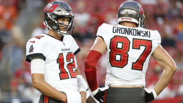 Buccaneers quarterback Tom Brady and tight end Rob Gronkowski wait for a play call during a preseason game.