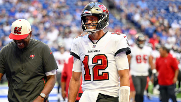 Buccaneers quarterback Tom Brady (12) smiles while he walks off the field before the preseason game against the Colts.