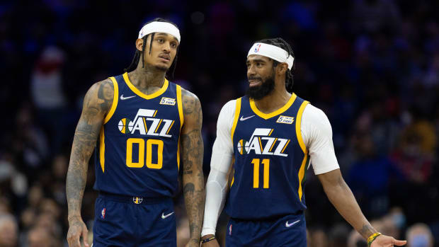 Utah Jazz guards Jordan Clarkson (00) and Mike Conley (11) talk during a timeout in the third quarter against the Philadelphia 76ers at Wells Fargo Center.