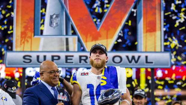 Feb 13, 2022; Inglewood, CA, USA; Los Angeles Rams wide receiver Cooper Kupp (10) holds the Lombardi Trophy as he is interviewed by NBC sports host Mike Tirico after defeating the Cincinnati Bengals during Super Bowl LVI at SoFi Stadium.
