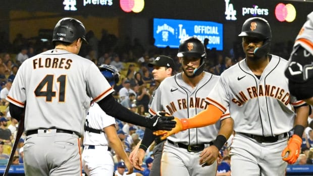 Sep 5, 2022; Los Angeles, California, USA; San Francisco Giants center fielder Lewis Brinson (29) is congratulated by third baseman Wilmer Flores (41) after hitting a two run home run in the second inning against the Los Angeles Dodgers at Dodger Stadium. Mandatory Credit: Jayne Kamin-Oncea-USA TODAY Sports