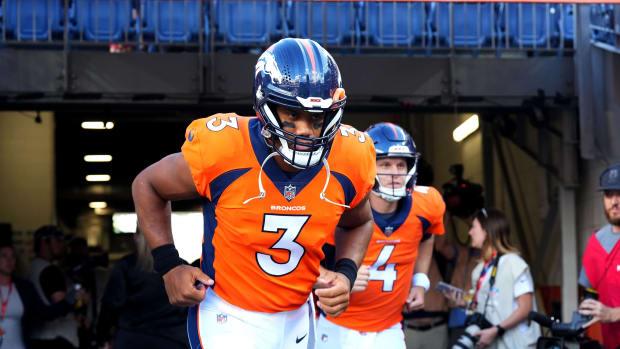 Denver Broncos quarterback Russell Wilson (3) runs on to the field before a preseason game against the Minnesota Vikings at Empower Field at Mile High.