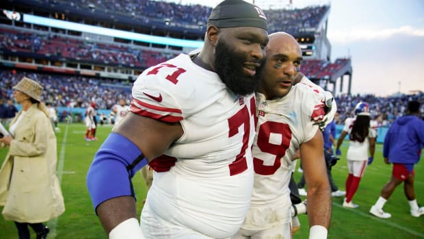 New York Giants linebacker Austin Calitro (59) and New York Giants defensive tackle Justin Ellis (71) celebrate after New York beat Tennessee 21-20 during the season opener at Nissan Stadium Sunday, Sept. 11, 2022, in Nashville, Tenn.