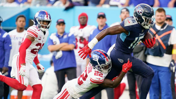 Tennessee Titans wide receiver Treylon Burks (16) picks up a first down as New York Giants cornerback Adoree' Jackson (22) tries to tackle him during the third quarter at Nissan Stadium.