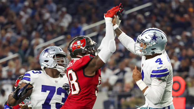 Sep 11, 2022; Arlington, Texas, USA; Dallas Cowboys quarterback Dak Prescott (4) hits his hand against Tampa Bay Buccaneers linebacker Shaquil Barrett (58) while throwing during the fourth quarter at AT&T Stadium.