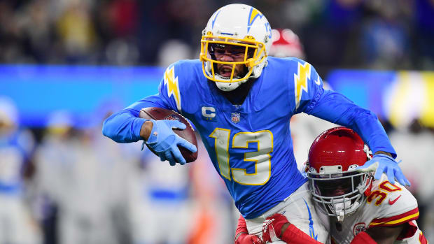Dec 16, 2021; Inglewood, California, USA; Los Angeles Chargers wide receiver Keenan Allen (13) runs the ball against Kansas City Chiefs cornerback Deandre Baker (30) during the first half at SoFi Stadium. Mandatory Credit: Gary A. Vasquez-USA TODAY Sports