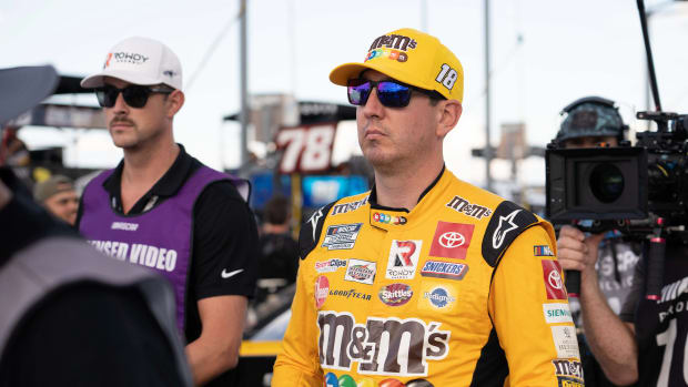 Sep 4, 2022; Darlington, South Carolina, USA; Kyle Busch, driver of the (18) M&M’s Toyota, arrives for driver introductions prior to the COOK OUT Southern 500 at Darlington Raceway.