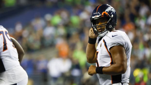 Denver Broncos quarterback Russell Wilson (3) returns to the sideline following a third down stop against the Seattle Seahawks during the fourth quarter at Lumen Field.