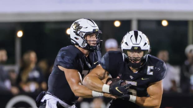UCF Knights quarterback John Rhys Plumlee (10) fakes a hand off to UCF Knights running back Isaiah Bowser (5)