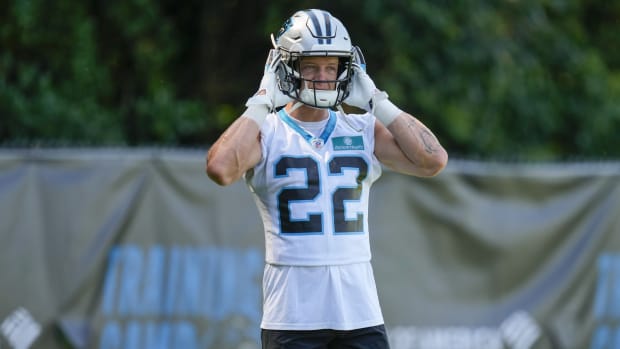 Jul 28, 2022; Spartanburg, SC, USA; Carolina Panthers running back Christian McAffrey (22) dons his helmet during the second day of training camp at Wofford College.