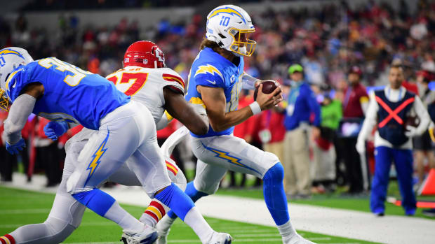 Dec 16, 2021; Inglewood, California, USA; Los Angeles Chargers quarterback Justin Herbert (10) runs the ball in for a touchdown against the Kansas City Chiefs during the first half at SoFi Stadium. Mandatory Credit: Gary A. Vasquez-USA TODAY Sports