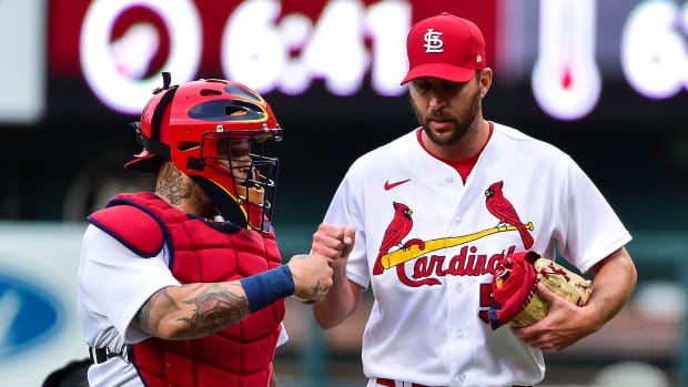 St. Louis Cardinals starting pitcher Adam Wainwright (50) and catcher Yadier Molina (4) walk in from the bullpen before a game against the Milwaukee Brewers at Busch Stadium.