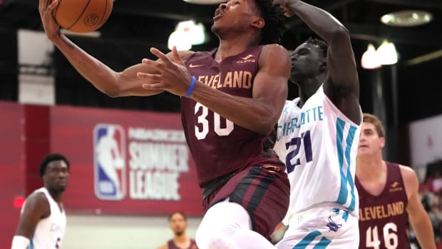 Cleveland Cavaliers guard Ochai Agbaji (30) shoots the ball while defended by Charlotte Hornets forward JT Thor (21) during an NBA Summer League game at Cox Pavilion.