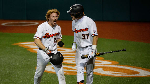 Oregon State left fielder Wade Meckler (now with the SF Giants), left, celebrates after crossing home plate to score for the Beavers Friday, June 3, 2022, at the 2022 NCAA Corvallis Regional