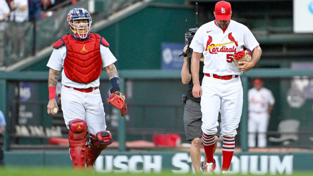 Sep 14, 2022; St. Louis, Missouri, USA;  St. Louis Cardinals catcher Yadier Molina (4) and starting pitcher Adam Wainwright (50) walk in from the bullpen before their 325th start as a battery breaking the MLB record before a game against the Milwaukee Brewers at Busch Stadium.
