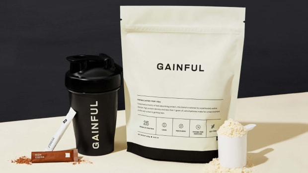 A bag of Gainful protein powder next to a shaker bottle