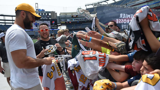 Former lacrosse player Paul Rabil signs autographs for fans prior to a match between Archers LC and Chrome LC at Gillette Stadium.