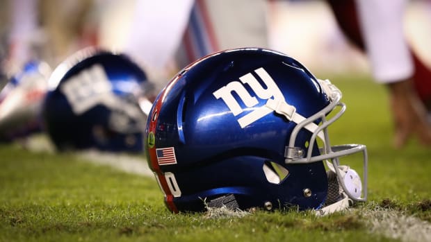 Oct 12, 2014; Philadelphia, PA, USA; The helmet of New York Giants quarterback Eli Manning (10) (not pictured) sits on the field as players stretch during warm ups before a game against the Philadelphia Eagles at Lincoln Financial Field. The Eagles defeated the Giants 27-0.