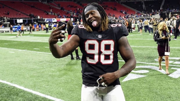 Atlanta Falcons defensive end Takkarist McKinley (98) does a selfie as he leaves the field after the Falcons defeated the New York Giants at Mercedes-Benz Stadium.