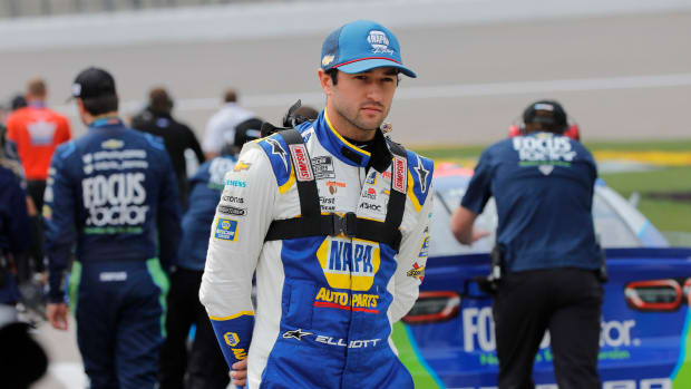 Chase Elliott stands on pit road as he waits to qualify for the NASCAR Cup Series auto race at Kansas Speedway in Kansas City, Kan., Saturday, Sept. 10, 2022.