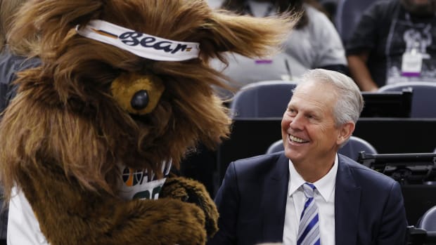 Danny Ainge is greeted by Jazz Bear as he watches pregame activities after being appointed Alternate Governor and CEO of Utah Jazz Basketball prior to their game against the LA Clippers at Vivint Arena.