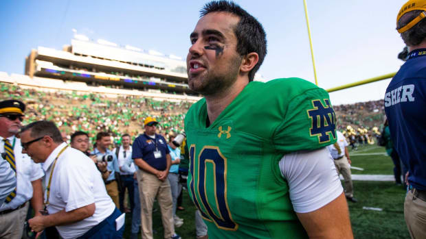Notre Dame quarterback Drew Pyne celebrates on the field after beating Cal.