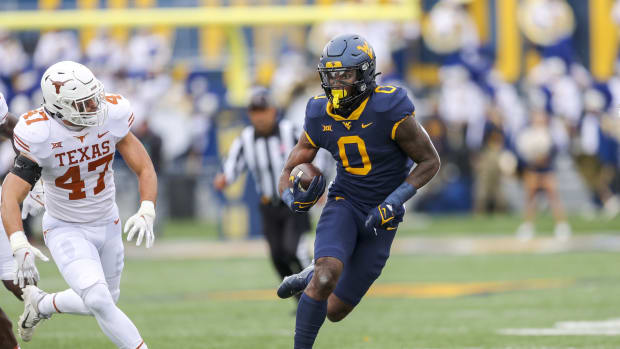 Nov 20, 2021; Morgantown, West Virginia, USA; West Virginia Mountaineers wide receiver Bryce Ford-Wheaton (0) makes a catch and runs for extra yards during the first quarter against the Texas Longhorns at Mountaineer Field at Milan Puskar Stadium.