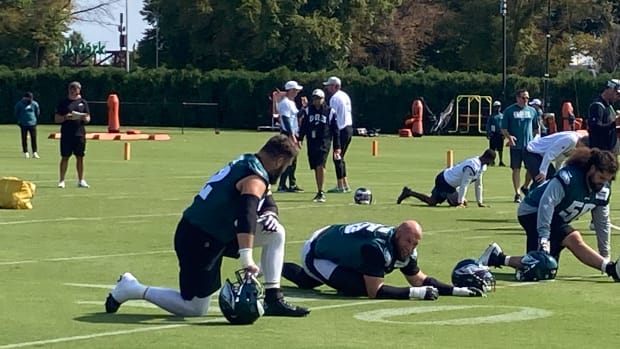 Jason Kelce, Lane Johson, and Isaac Seumalo (from left to right) get loose prior to a practice in preparation for the home opener vs. the Vikings