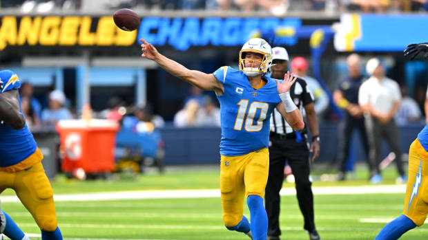 Sep 11, 2022; Inglewood, California, USA; Los Angeles Chargers quarterback Justin Herbert (10) as he throws a touchdown pass to Los Angeles Chargers wide receiver DeAndre Carter (not pictured) in the second quarter against the Las Vegas Raiders at SoFi Stadium. Mandatory Credit: Jayne Kamin-Oncea-USA TODAY Sports