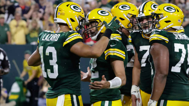 Green Bay Packers wide receiver Allen Lazard (13) celebrates with teammate quarterback Aaron Rodgers (12) after catching a 5-yard touchdown pass during the first half of an NFL football game against the Chicago Bears Sunday, Sept. 18, 2022, in Green Bay, Wis. (AP Photo/Mike Roemer)