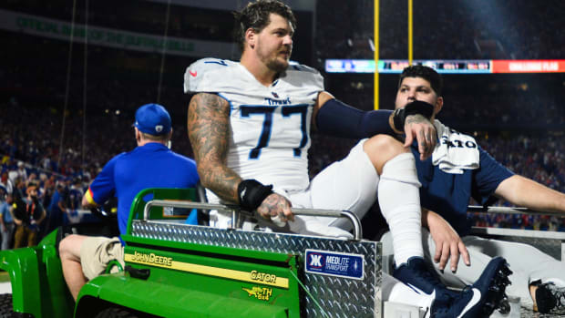 Tennessee Titans offensive tackle Taylor Lewan (77) is carted off the field during the first half of an NFL football game against the Buffalo Bills, Monday, Sept. 19, 2022, in Orchard Park, N.Y. (AP Photo/Adrian Kraus)