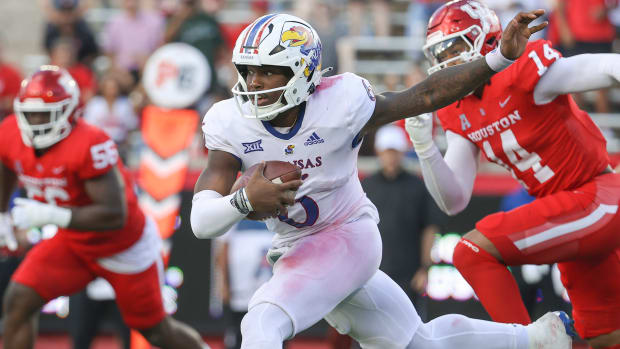 Kansas Jayhawks quarterback Jalon Daniels (6) runs with the ball for a first down during the second quarter against the Houston Cougars at TDECU Stadium.