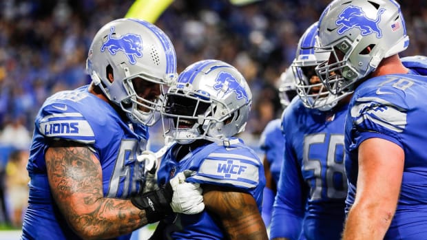 Detroit Free PressDetroit Lions running back D'Andre Swift, center, celebrates a touchdown with left tackle Taylor Decker, left, against the Washington Commanders during the second half at Ford Field.