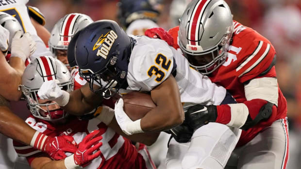 Sep 17, 2022; Columbus, Ohio, USA; Toledo Rockets running back Willie Shaw III (32) is tackled by Ohio State Buckeyes defensive end Caden Curry (92) and Ohio State Buckeyes defensive tackle Tyleik Williams (91) during Saturday's NCAA Division I football game at Ohio Stadium. Mandatory Credit: Barbara Perenic/Columbus Dispatch

Ncaa Football Toledo Rockets At Ohio State Buckeyes